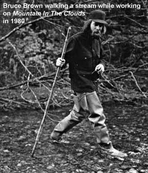 Bruce Brown walking a stream while working on Mountain in the Clouds in 1980 (Mary Randlett photo)