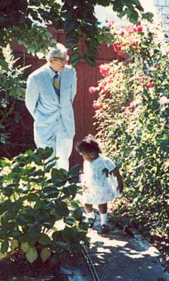 Professor Malcolm J. Brown walking in the garden with his grandaughter Laurel Brown, Seattle, WA, July 1986